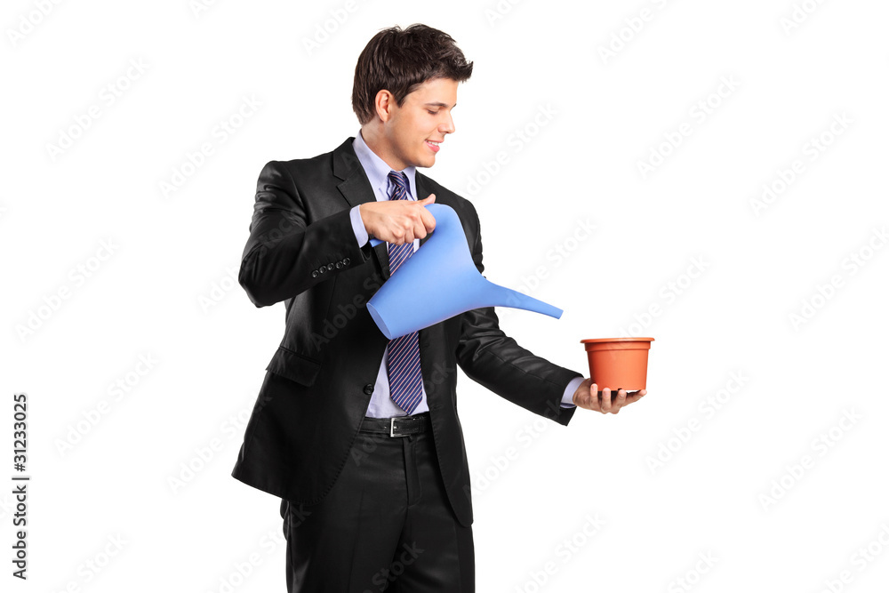 Businessman holding an empty flower pot and watering can Businessman holding an empty flower pot and watering can