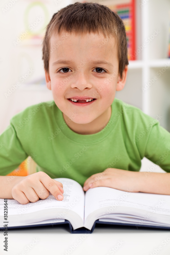 Happy elementary school boy practice reading Happy elementary school boy practice reading