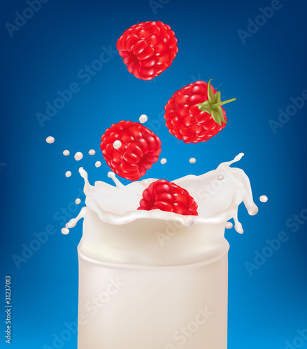 Raspberry fruits falling into the milk splash in a glass.
