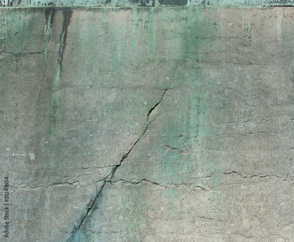 Obraz premium cracked worn stone and bronze surface from a monument