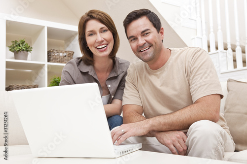 Happy Man Woman Couple Using Laptop Computer At Home