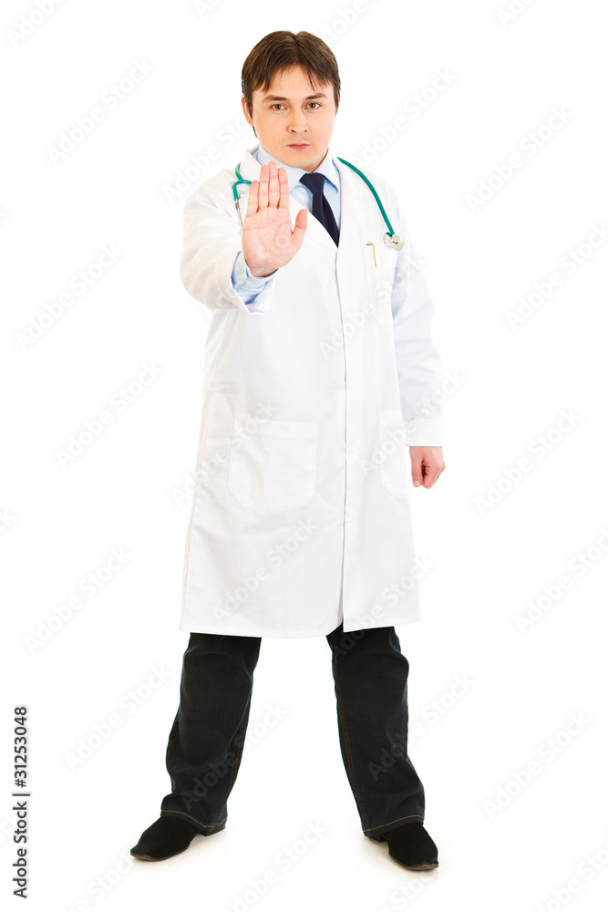 Authoritative medical doctor showing stop gesture isolated Authoritative medical doctor showing stop gesture isolated