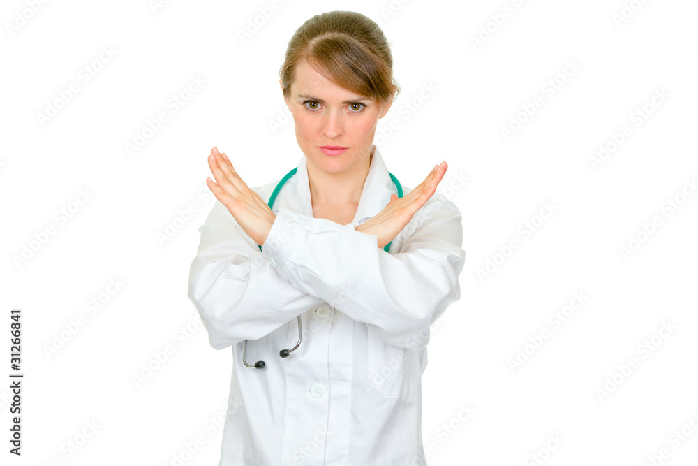 Serious female doctor with crossed arms. Forbidden gesture.