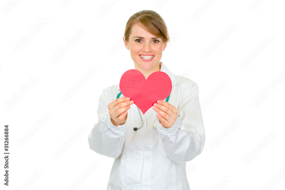 Smiling medical female doctor holding paper heart in hands Smiling medical female doctor holding paper heart in hands