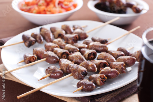 Grilled chicken hearts on skewers