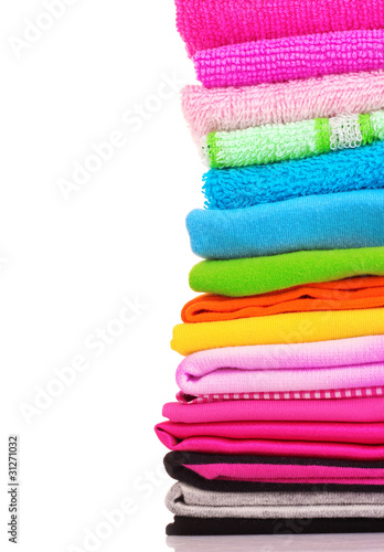 Pile of colorful clothes over white background © Africa Studio