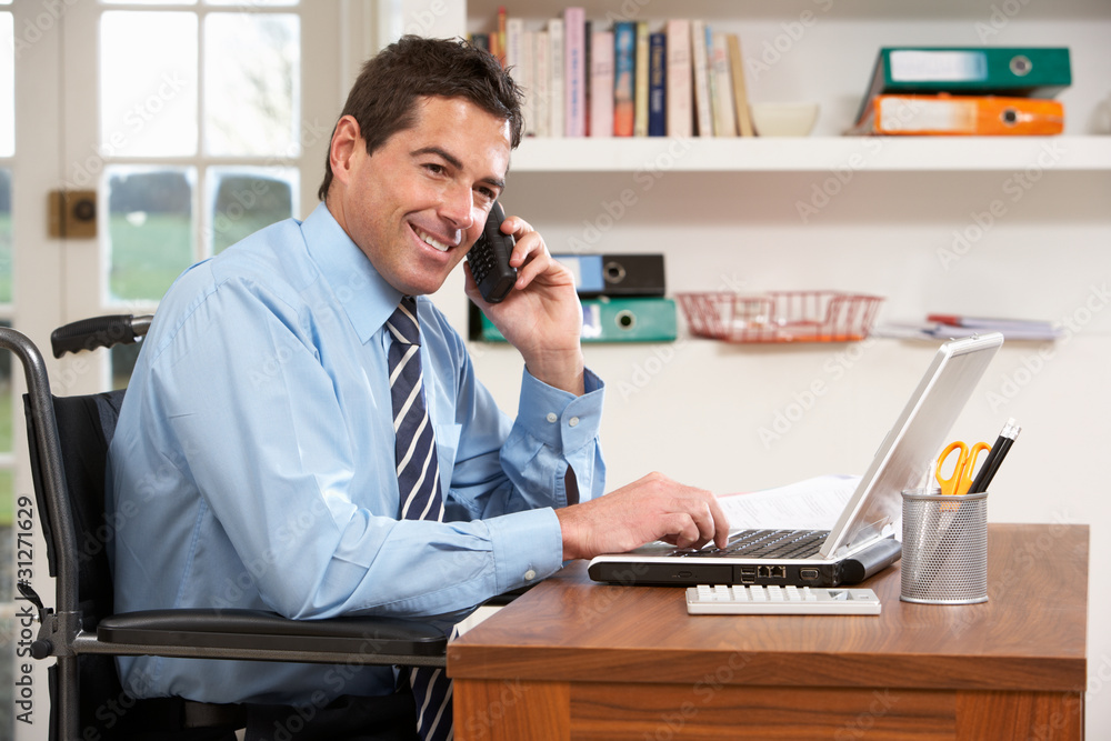 Man Working From Home Using Laptop On Phone Man Working From Home Using Laptop On Phone