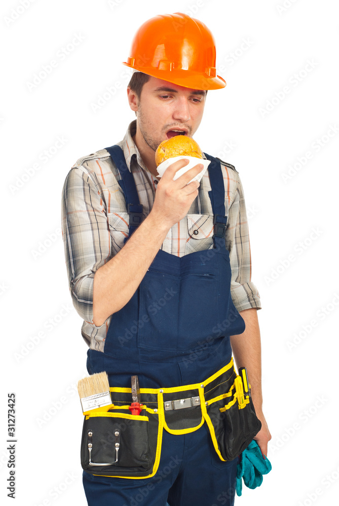 Builder man eating sandwich in a break Builder man eating sandwich in a break