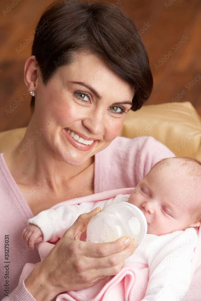 Portrait Of Mother Feeding Newborn Baby At Home Portrait Of Mother Feeding Newborn Baby At Home