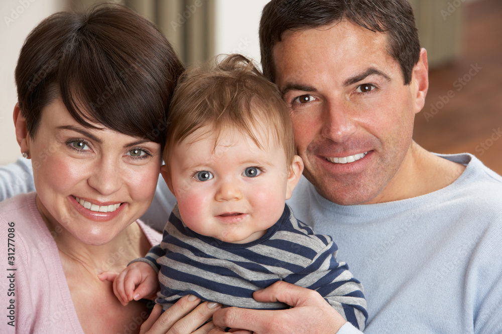 Portrait Of Proud Parents With Baby Son At Home Portrait Of Proud Parents With Baby Son At Home
