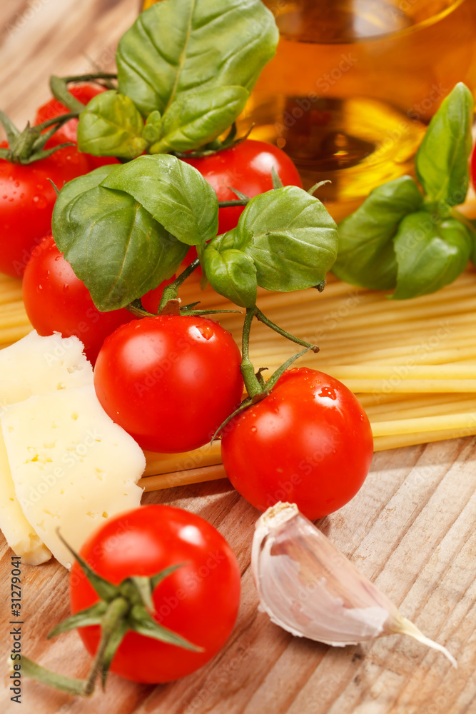 pasta, olive oil and tomatoes on the wood background pasta, olive oil and tomatoes on the wood background