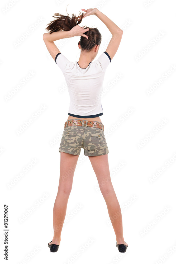 .Beautiful young woman in shorts looking at wall. Rear view. .Beautiful young woman in shorts looking at wall. Rear view.