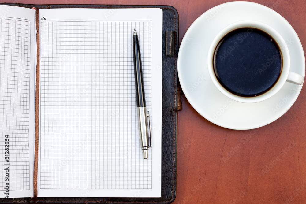 Coffee cup, notebook and pen Coffee cup, notebook and pen