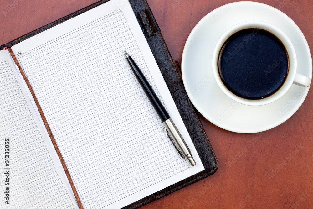 Coffee cup, notebook and pen Coffee cup, notebook and pen
