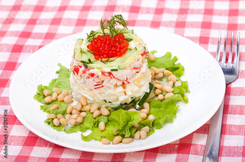 Salad of vegetables and crab with red caviar