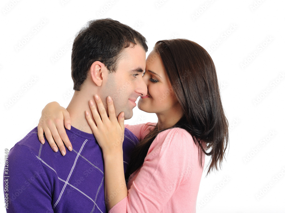 pretty young couple in love embracing. isolated on white backgro pretty young couple in love embracing. isolated on white backgro