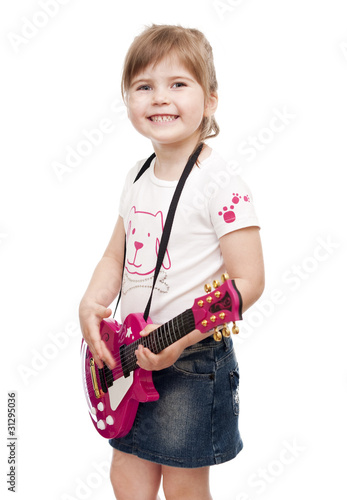 Little girl playing toy pink electric guitar