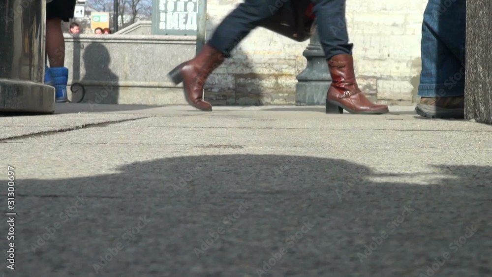 The feet of pedestrians, and passers- by The feet of pedestrians, and passers- by