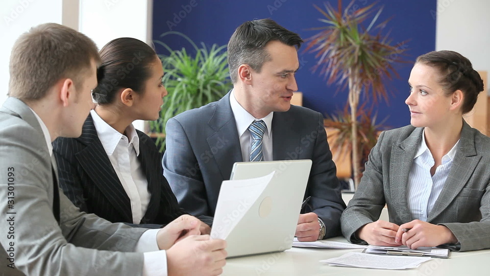 Businesspeople sitting at the table and discussing Businesspeople sitting at the table and discussing