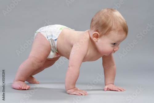 Foto Little boy in pampers crawling