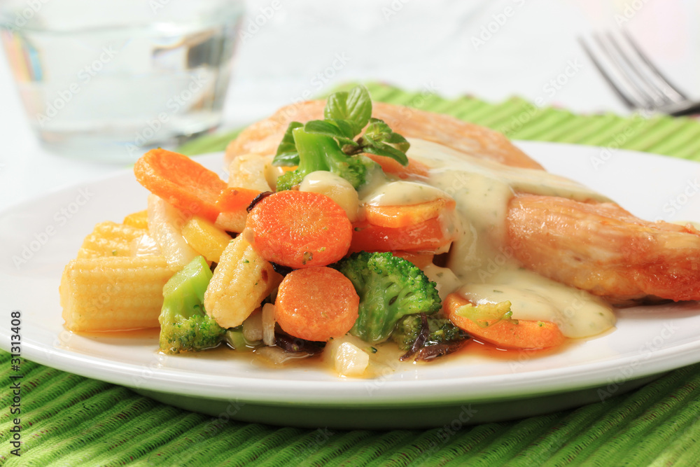Chicken breast and mixed vegetables poured with sauce Chicken breast and mixed vegetables poured with sauce