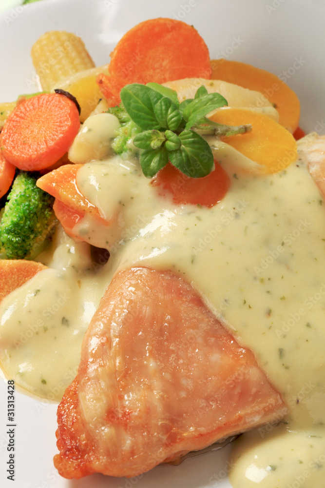 Chicken breast and mixed vegetables poured with sauce Chicken breast and mixed vegetables poured with sauce