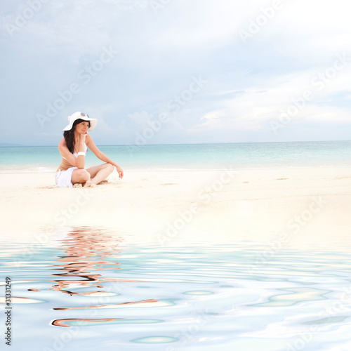 Young fashion woman on the beach