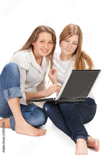 two young happy student girl work on laptop