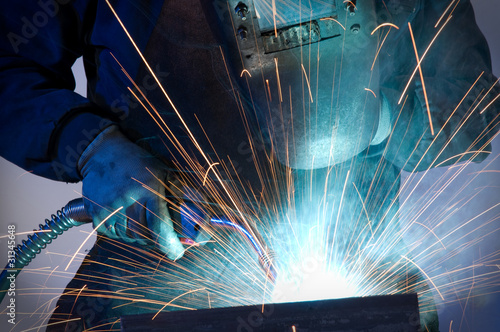 Worker welding steel close up.