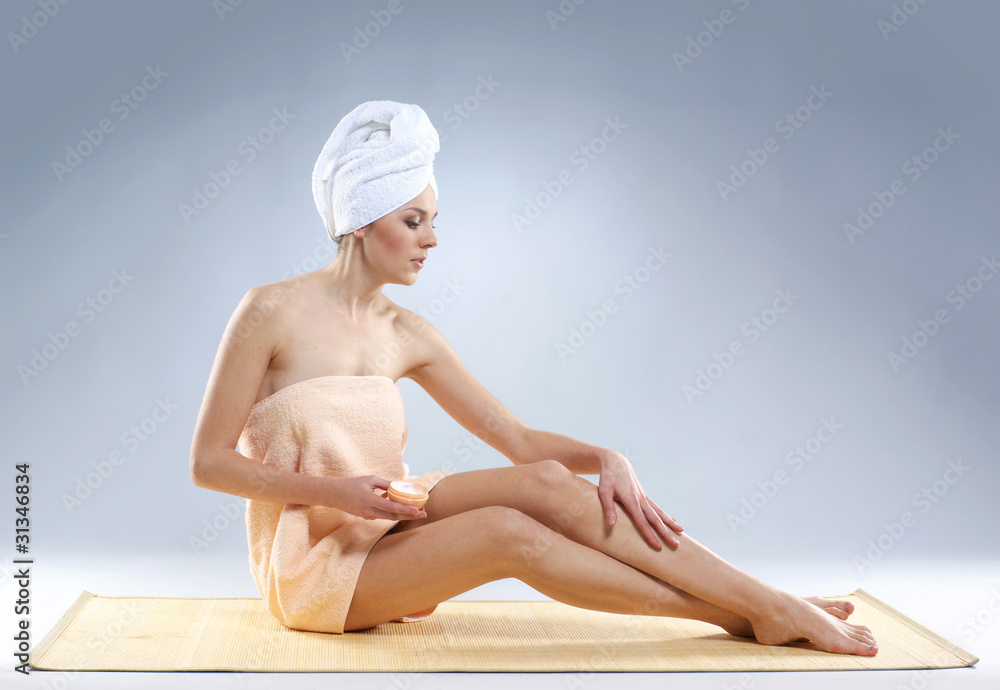 A young and sexy Caucasian woman is pampering her body A young and sexy Caucasian woman is pampering her body
