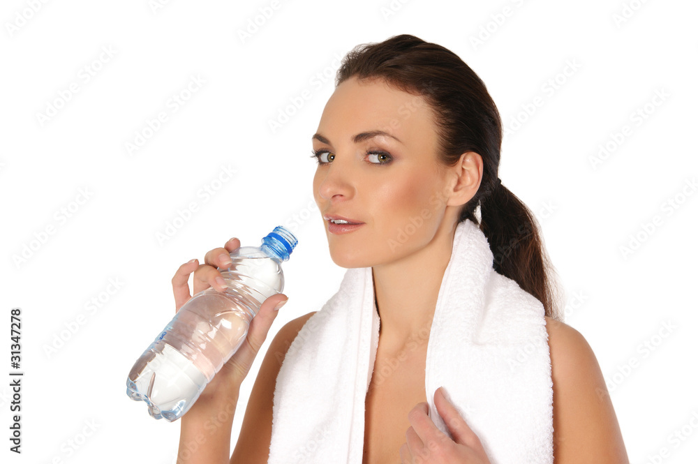 A young and sporty brunette woman is drinking fresh water A young and sporty brunette woman is drinking fresh water
