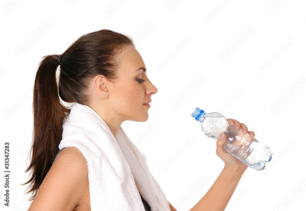 A young and sporty brunette woman is drinking fresh water A young and sporty brunette woman is drinking fresh water
