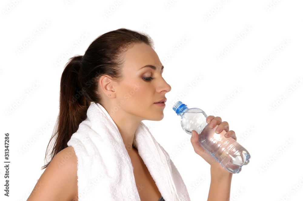 A young and sporty brunette woman is drinking fresh water A young and sporty brunette woman is drinking fresh water