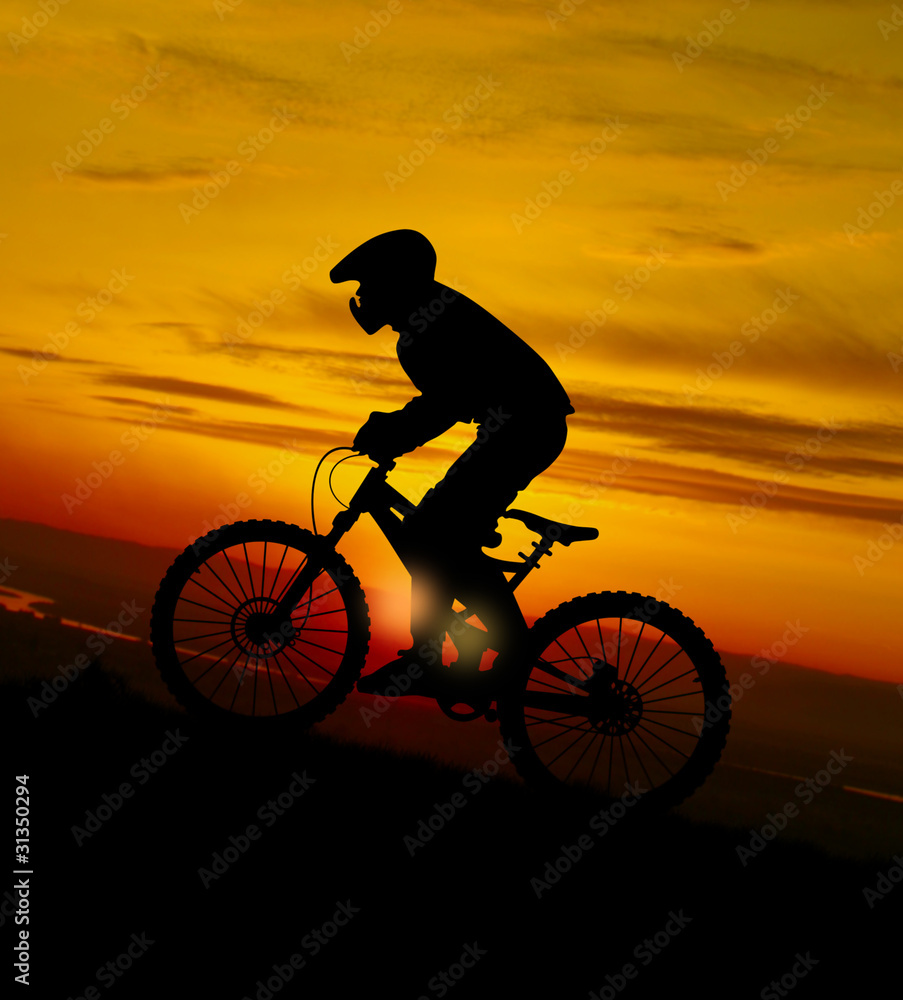 Fototapeta premium Mountain biker at sunset