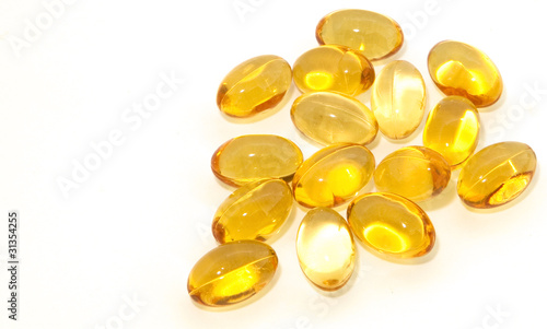 Oil vitamins yellow capsule on the white background
