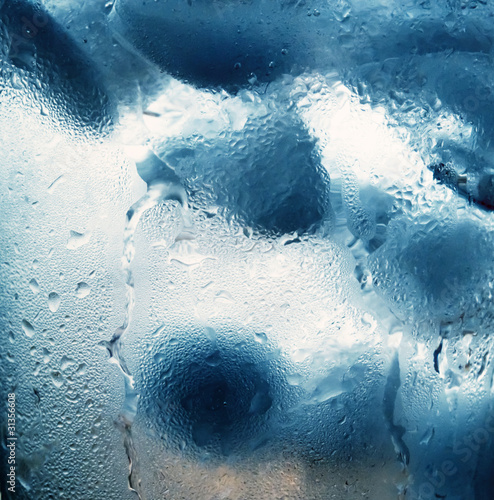 Ice cubes in the lumen of a sweaty glass.