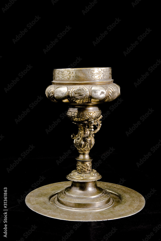 Old silver cup isolated on black
