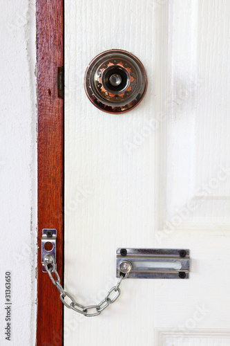 Door locked with chain and knob