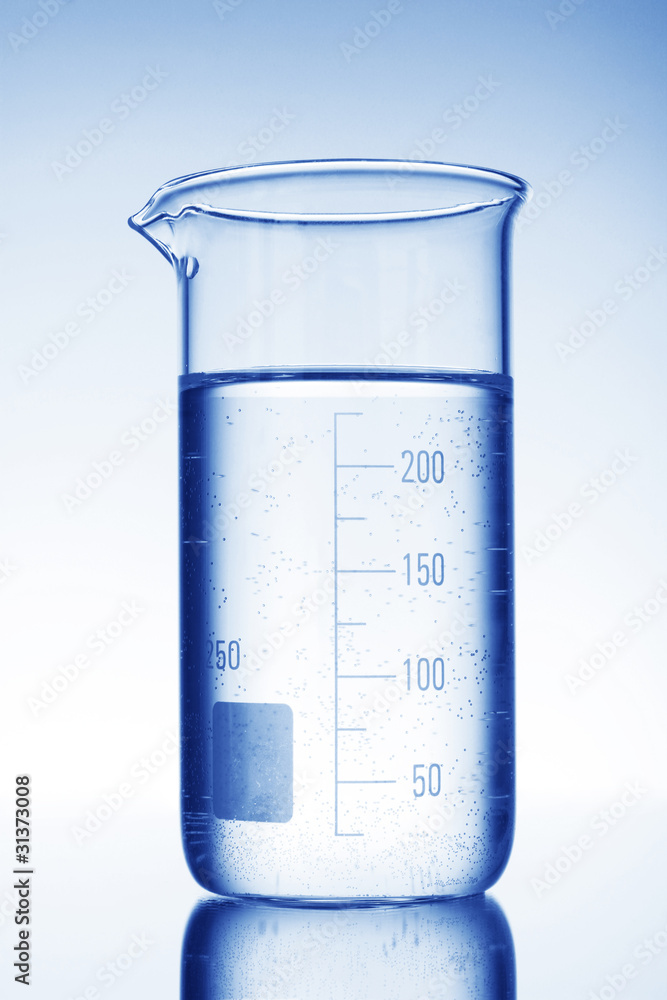 Graduated beaker on blue background Graduated beaker on blue background