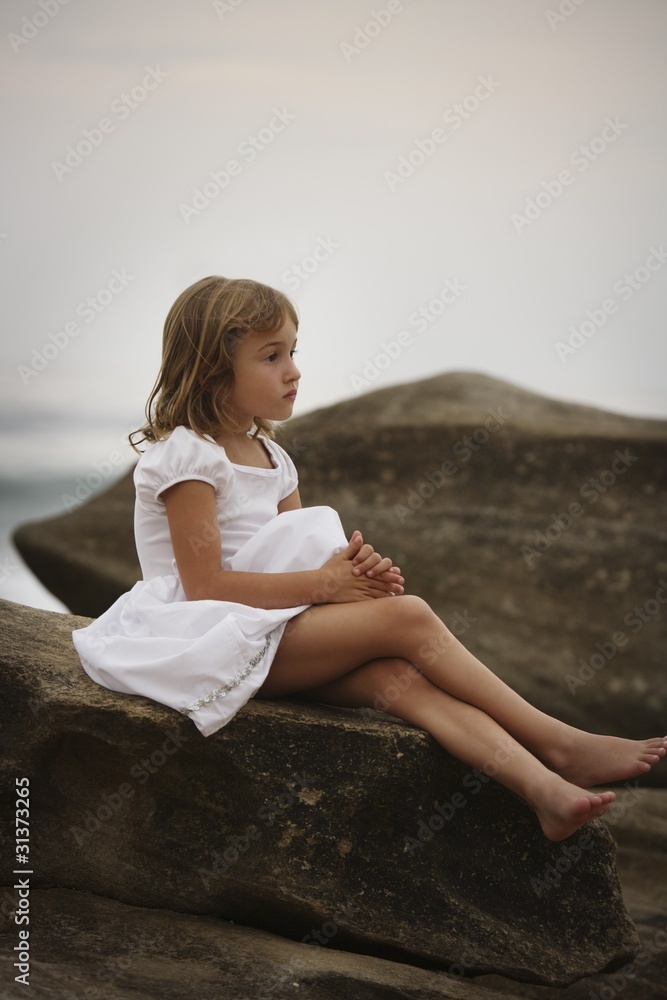 Girl Sitting On A Rock