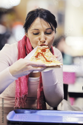 woman eat pizza food at restaurant