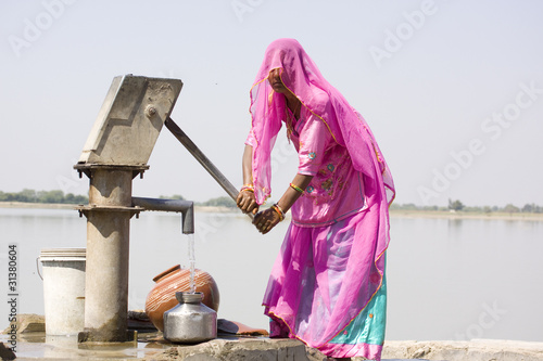 woman filling drinking water, rural Rajasthan , India
