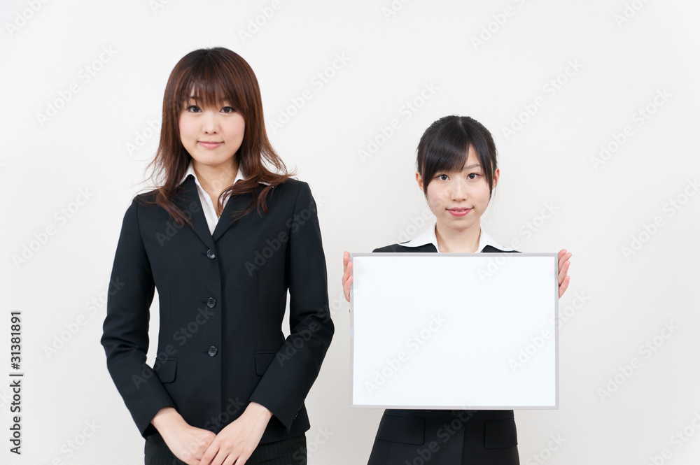 two asian businesswomen with blank whiteboard two asian businesswomen with blank whiteboard