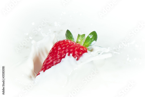 strawberry splashing into milk