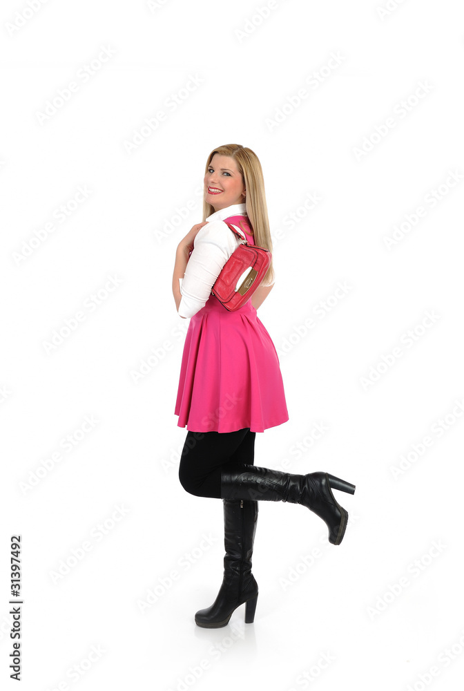 pretty shopping woman in pink dress standing. studio shot. isola pretty shopping woman in pink dress standing. studio shot. isola