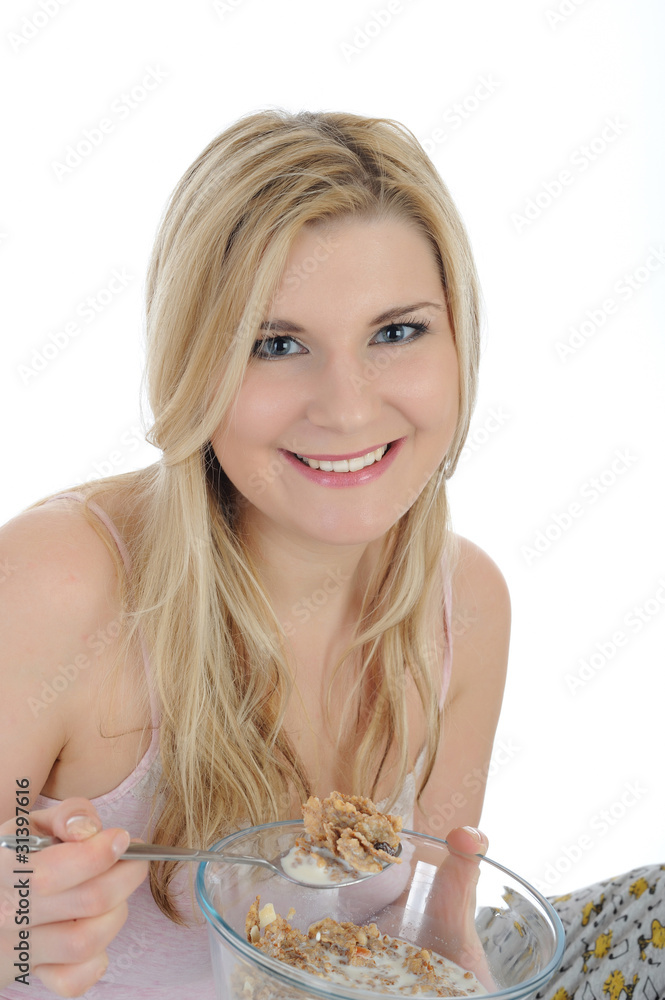 Pretty woman having muesli cereals for breakfast. isolated on wh Pretty woman having muesli cereals for breakfast. isolated on wh