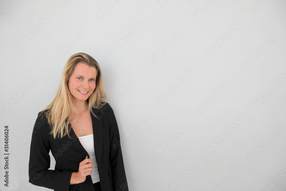 Beautiful businesswoman standing on grey background Beautiful businesswoman standing on grey background