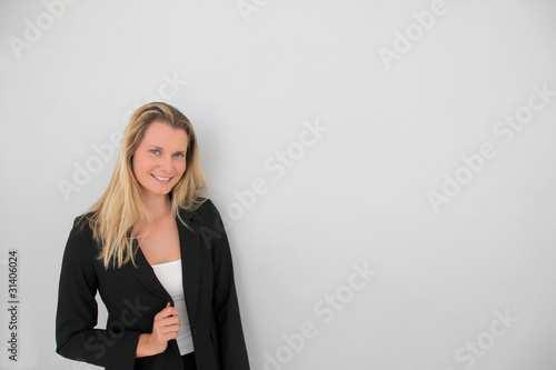 Beautiful businesswoman standing on grey background