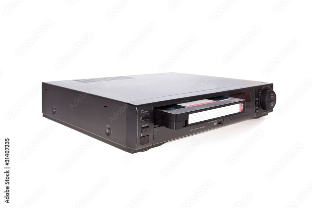 Old Video Cassette Recorder ejecting tape isolated on white Old Video Cassette Recorder ejecting tape isolated on white