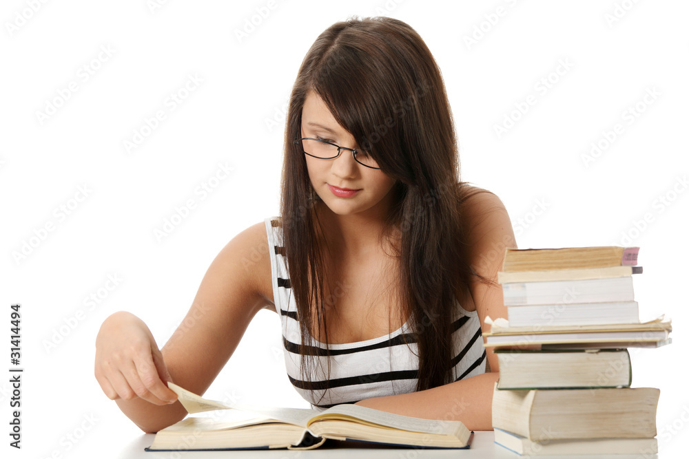 Young student woman with lots of books studing. Young student woman with lots of books studing.